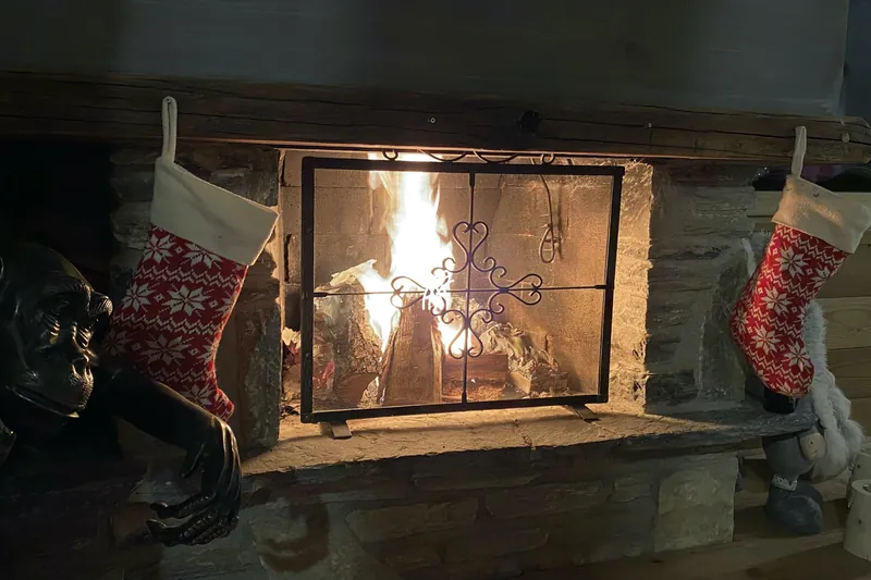 A fire lit in the living room of Chalet Cervo, Crans-Montana