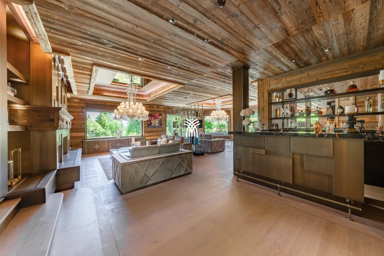 The open living room and bar of Chalet Christiana, under an old-wood ceiling