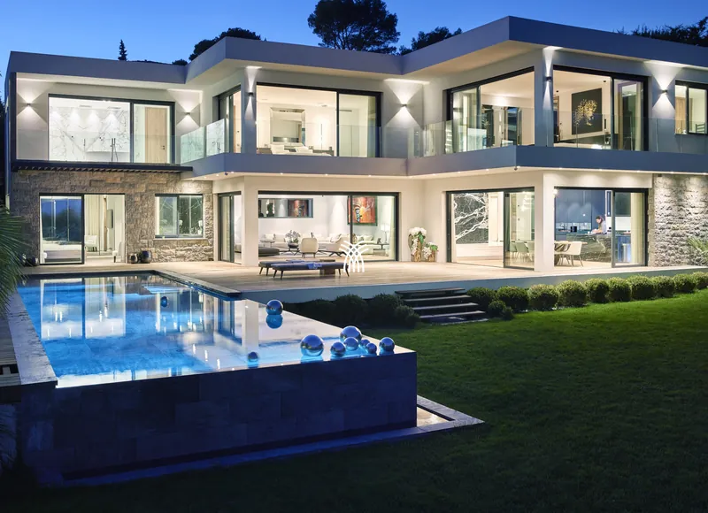 Villa Mila in Mougins, its pool lit at dusk